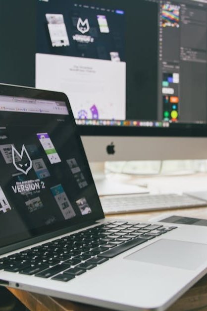 A stylish workspace featuring a laptop and monitors displaying design software.